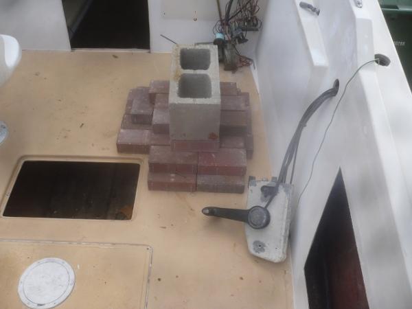 I left the bottom skin intact and cut out the top skin and the wet/rotten wood.  After glassing in new wood, I glassed the top skin back on, using bricks to weight it down.